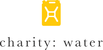 A logo for charity water with a yellow container on a white background.