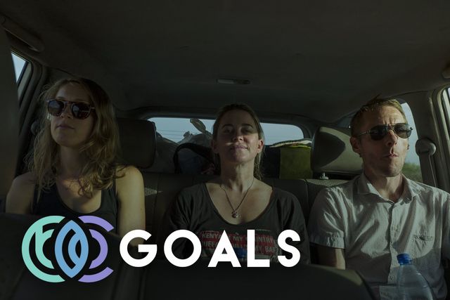 Three people in a car with the word goals to signify Sustainable Development Goals on the bottom