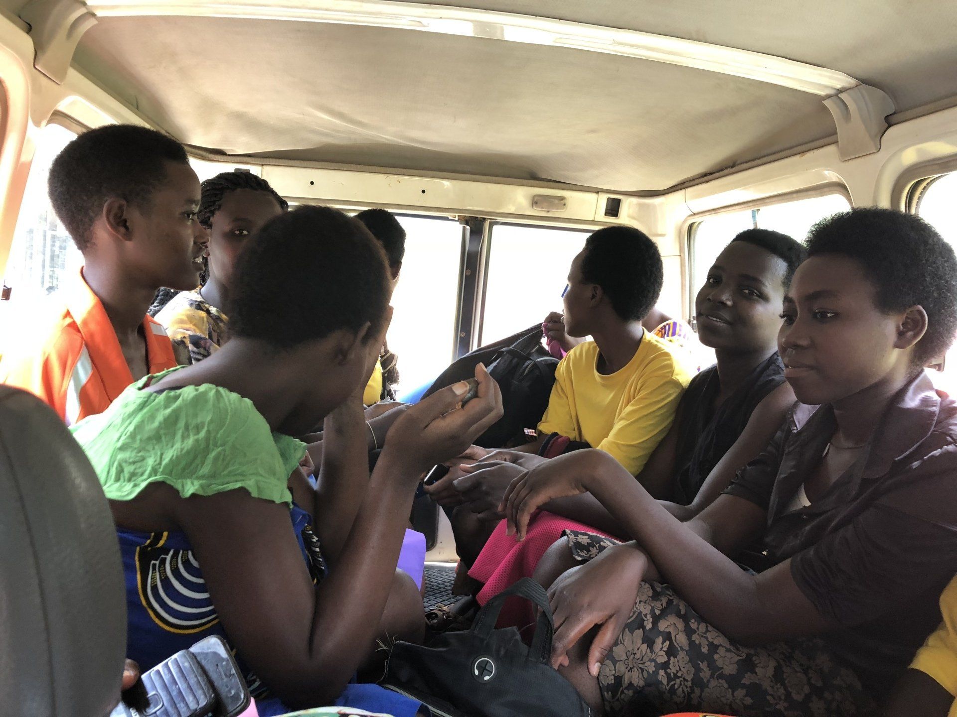 A group of people are sitting in the back of a car