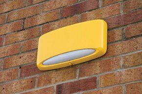 For a great service, at a great rate, call us today Yellow burglar alarm on a wall