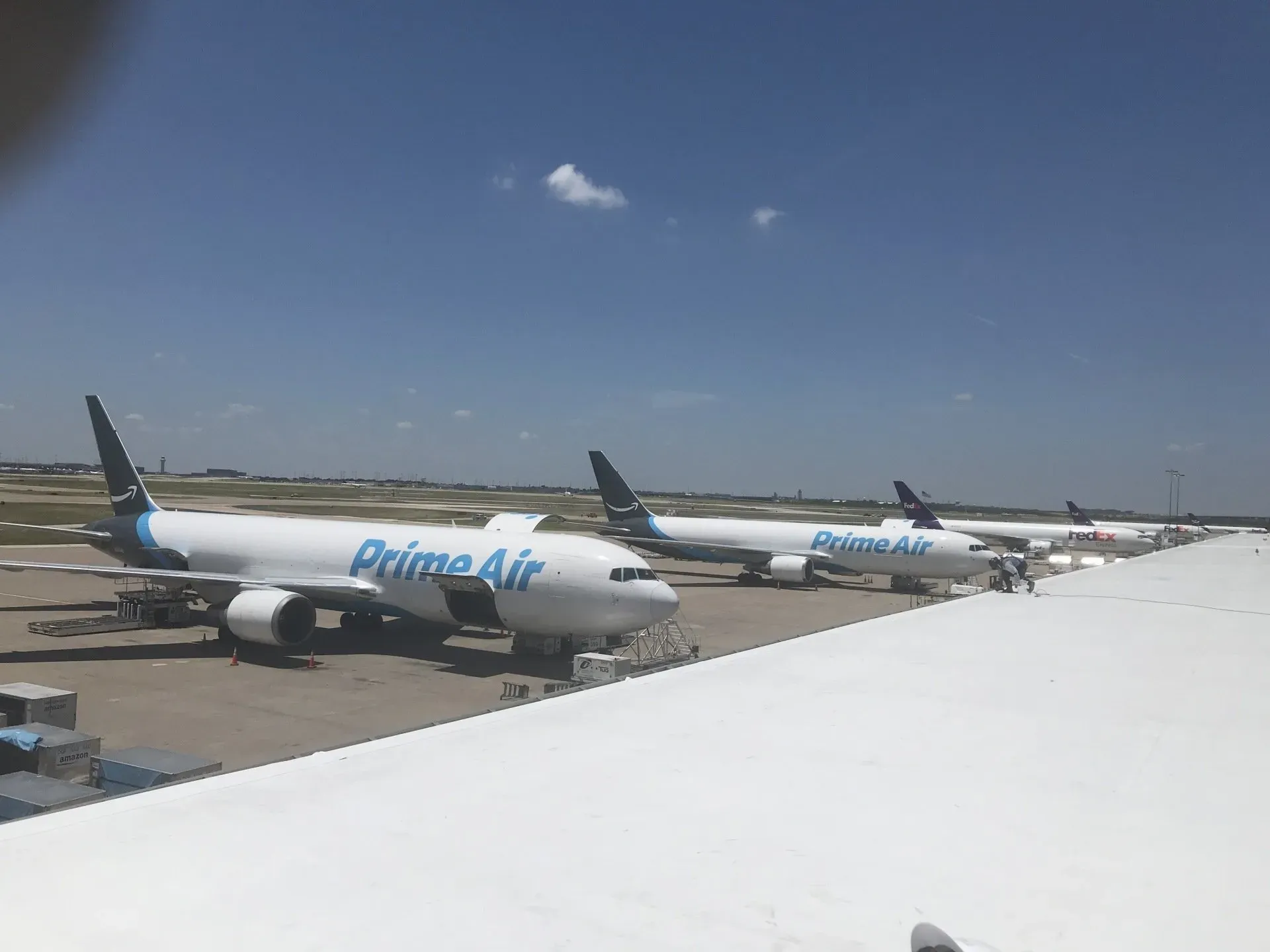 Three prime air planes are parked on the tarmac at an airport