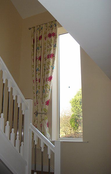 Floral fabric pencil pleat curtain on Stairs