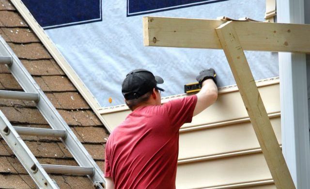 Contractor checking the level using the device while doing the repair
