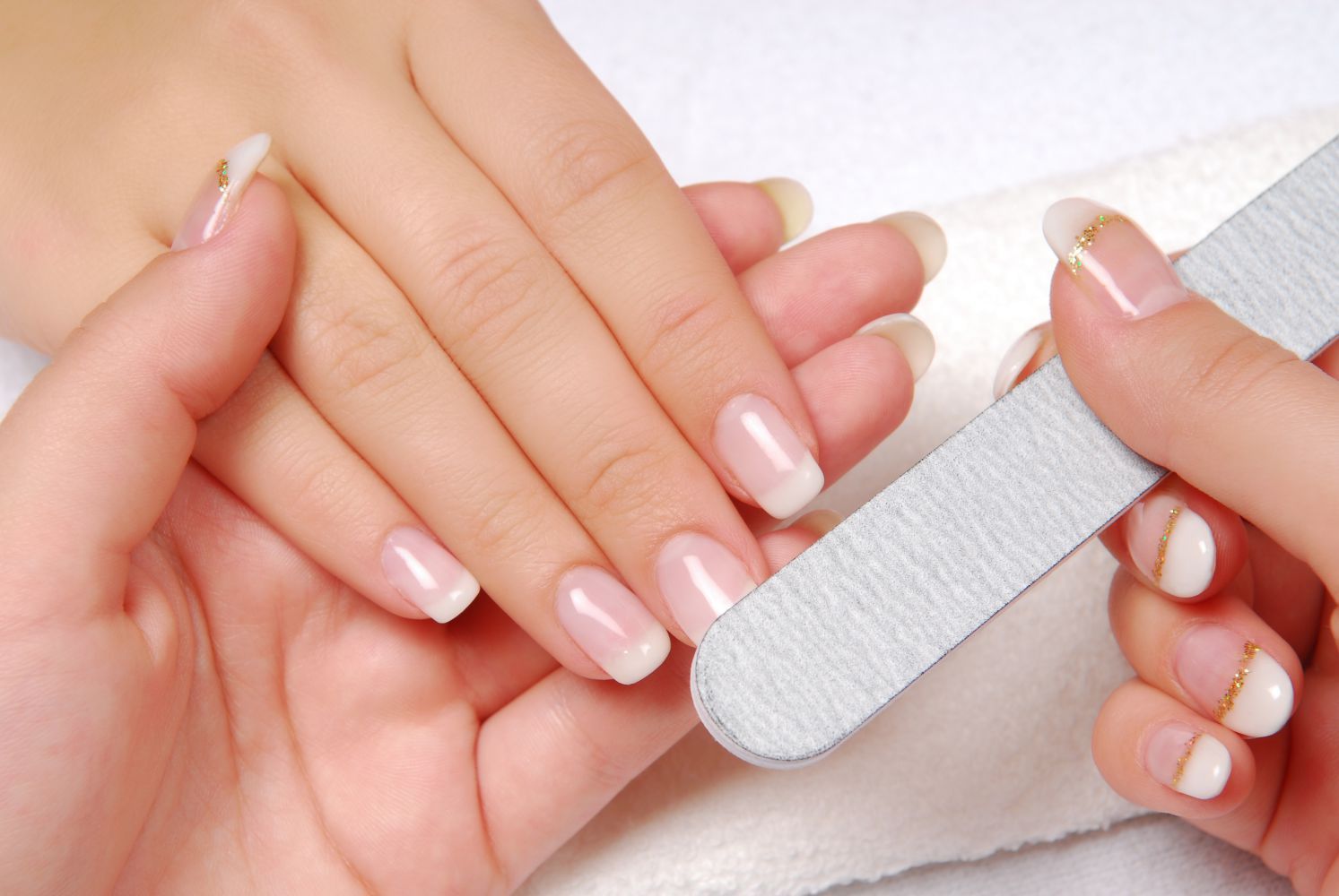 Hands receiving manicure at our nail salon in Kailua, HI