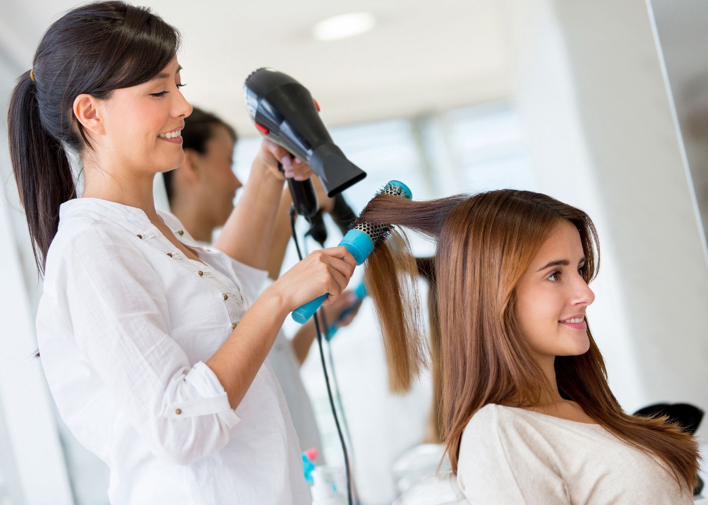 Woman getting a haircut at our hair and nail salon in Kailua, HI