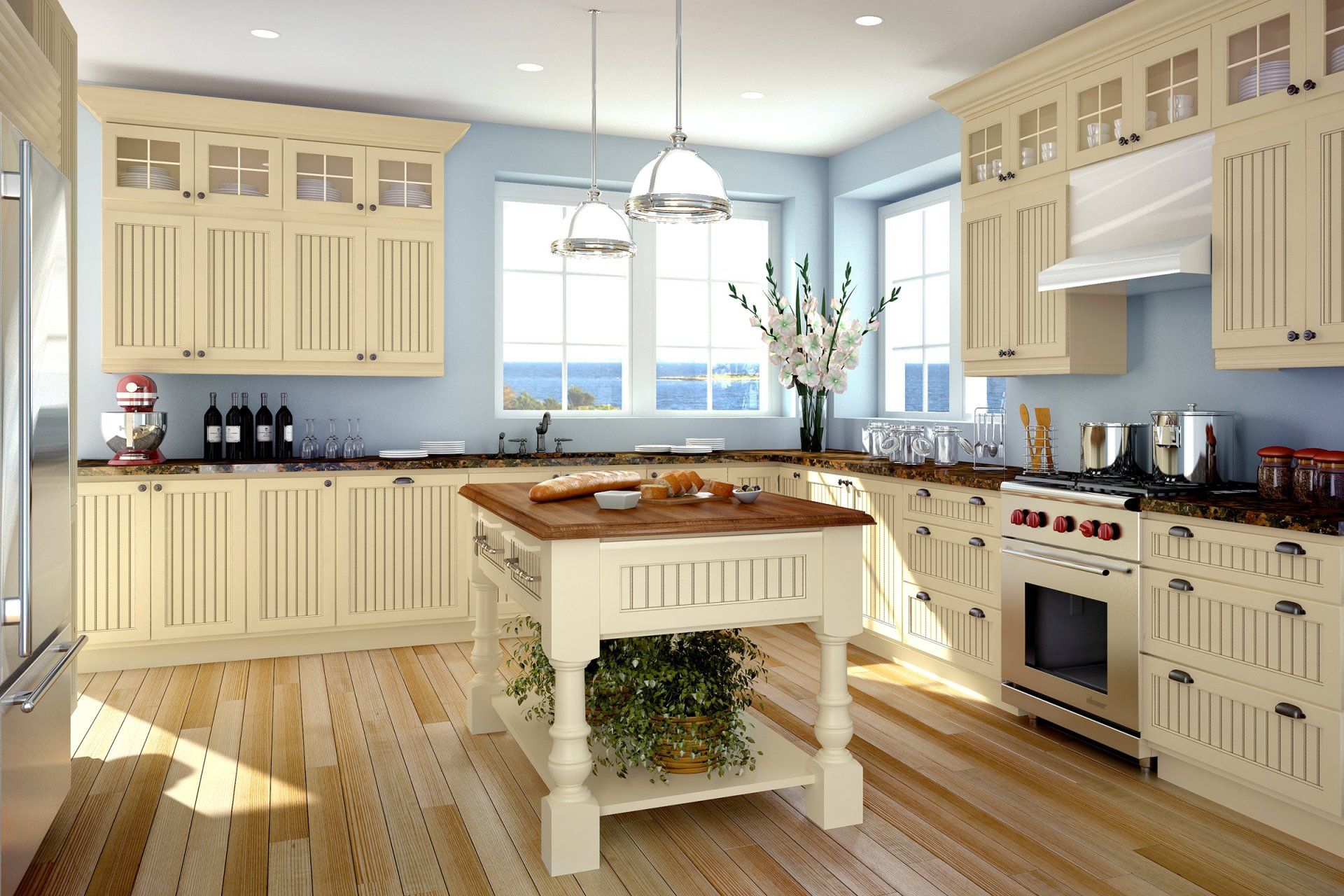 Bright cream kitchen with island, large windows, wood floors, and stainless steel appliances.