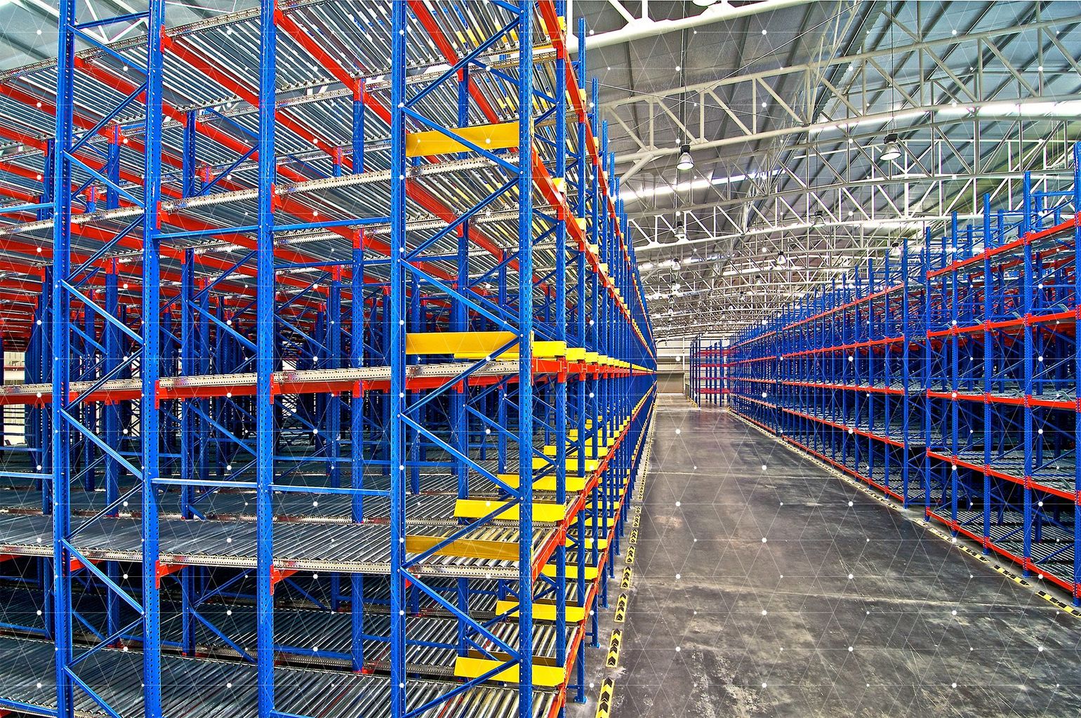 A warehouse filled with lots of blue and red shelves.