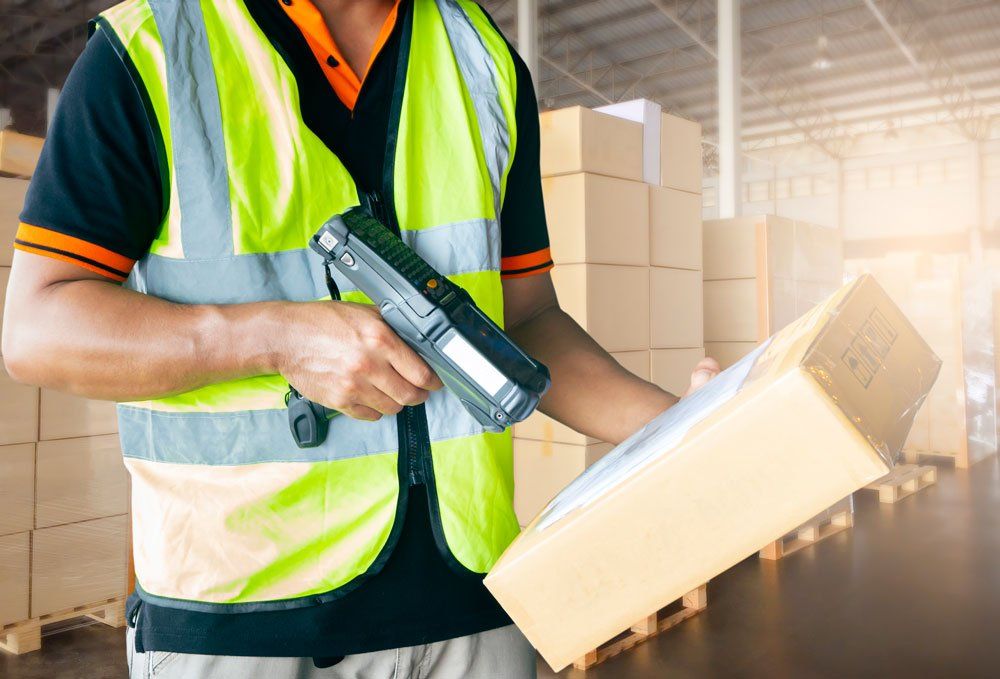 Warehouse Worker Holding Barcode Scanner — San Antonio, TX  — Lone Star Pallet Rack