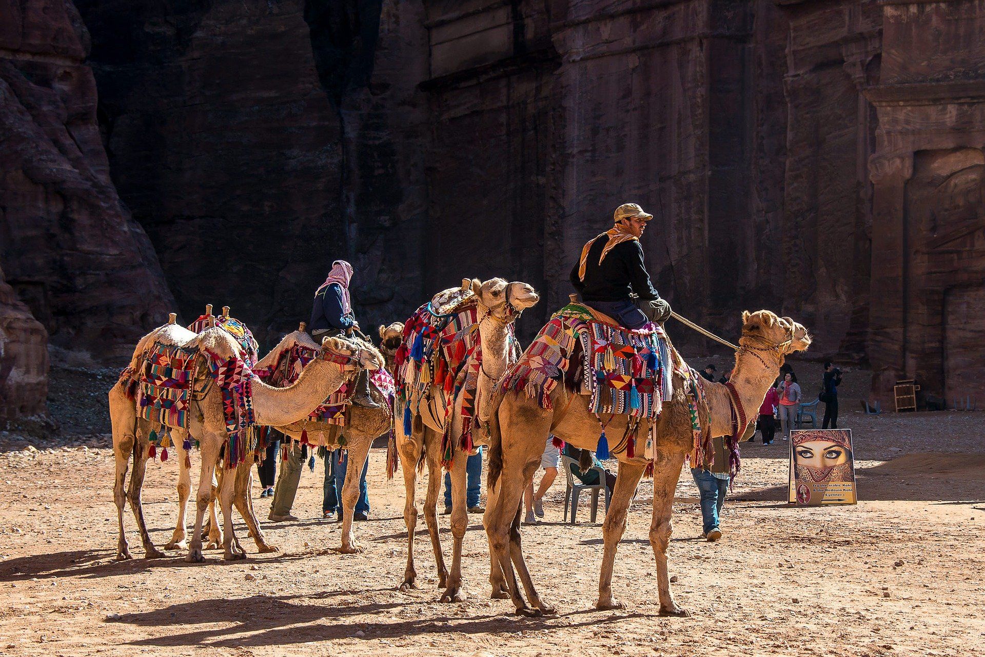 Community-Based Tourism Men riding camels