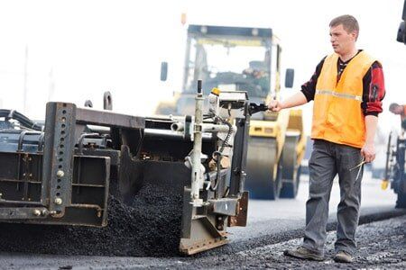 Man Working on the Road — Asphalt Paving Company in Keller, TX Man Working on the Road — Asphalt Paving Company in Keller, TX