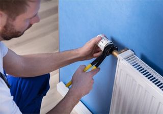 Technicians — Repairman Fixing Radiator with Wrench in Andover, NJ Technicians — Repairman Fixing Radiator with Wrench in Andover, NJ