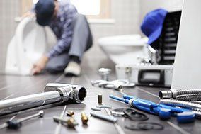 Water Heaters — Plumber At Work In A Bathroom in Shreveport, LA