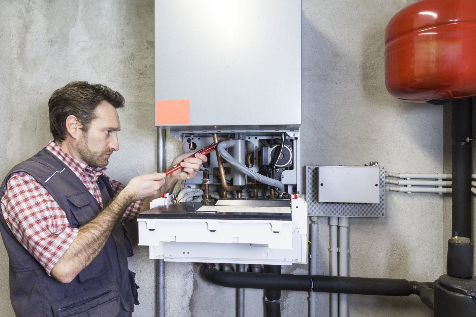 Leaky — Plumber repairing a condensing boiler in Shreveport, LA Leaky — Plumber repairing a condensing boiler in Shreveport, LA