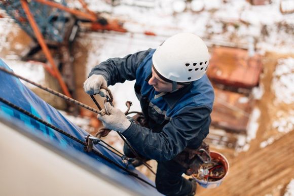 Painter securing his safety harness