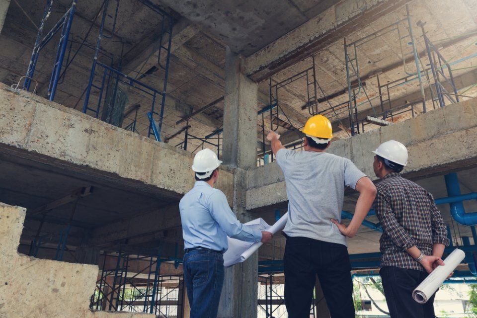 contractor pointing at the flaws in the building