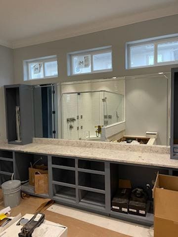 large master bathroom under construction with glass shower walls