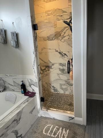 glass shower door and marble shower walls