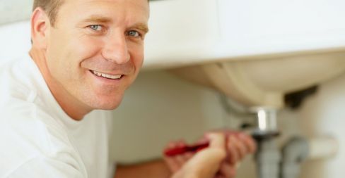 Plumber fixing a sink