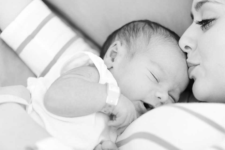 mother kissing newborn baby - Heavenly Hands Birthing Center
