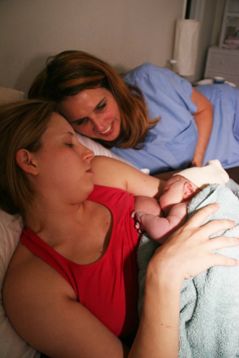 mother and midwife laying with sleeping baby - Heavenly Hands Birthing Center