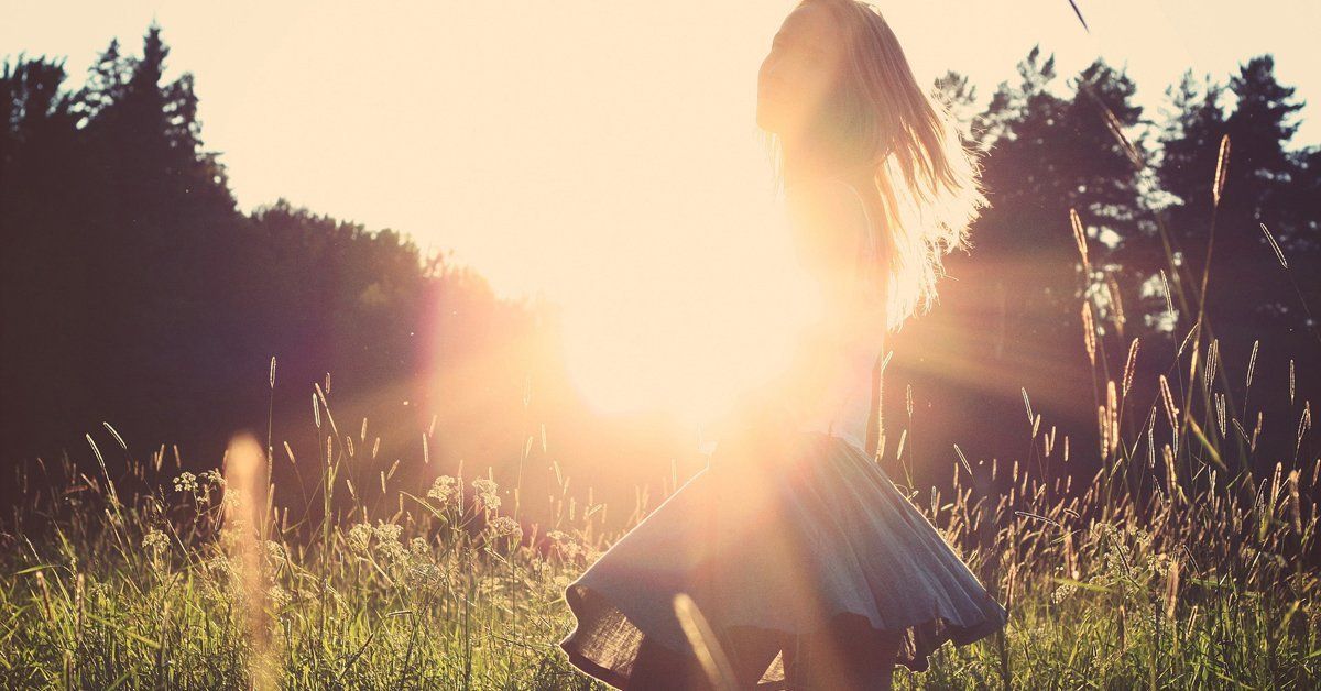 Girl in dress running in a field