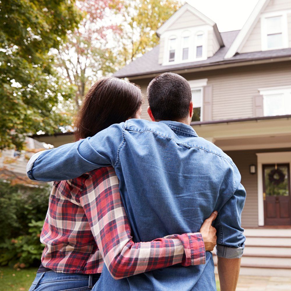 Couple Standing In Front Of House — Fowler, CO — Total Concept Couple Standing In Front Of House — Fowler, CO — Total Concept
