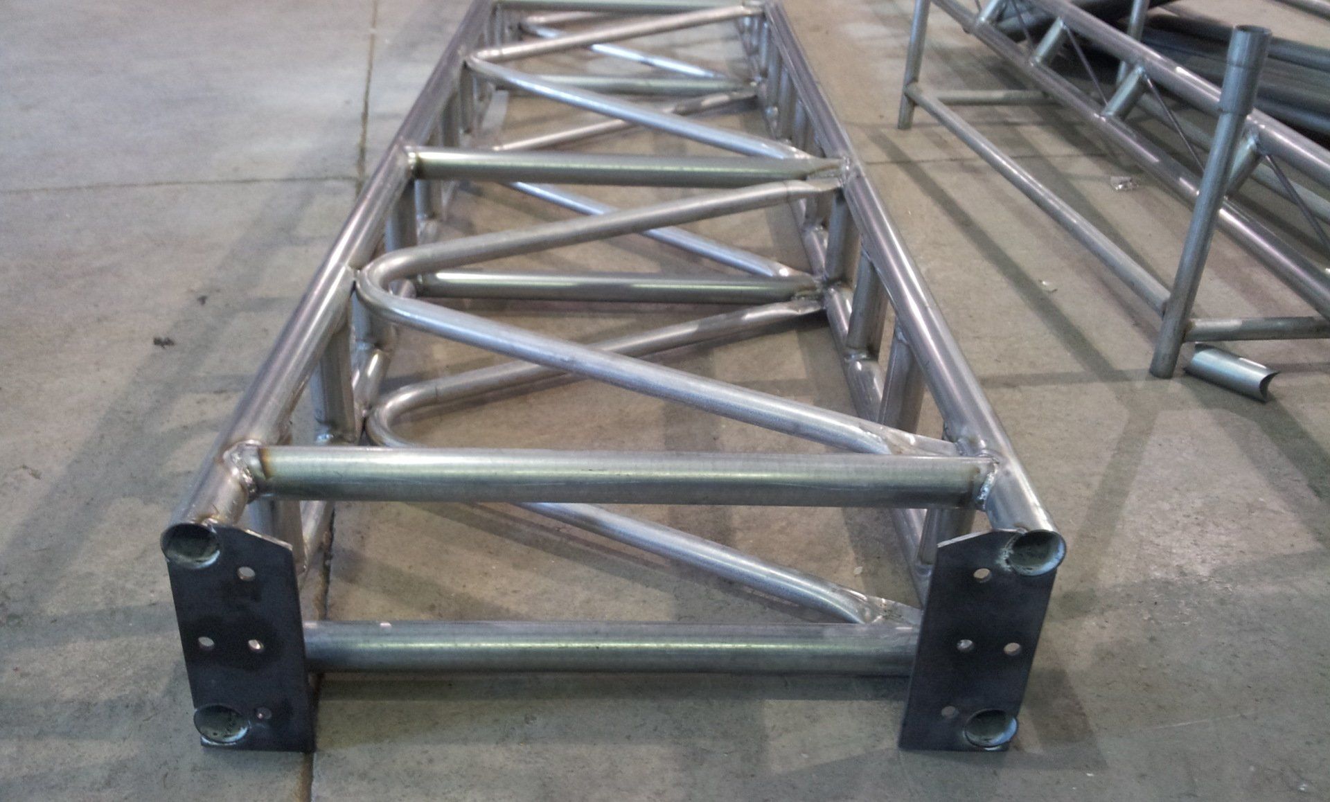 A metal structure is sitting on a concrete floor