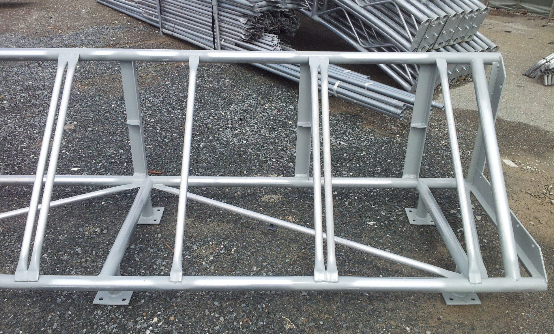 A metal structure is sitting on a gravel road