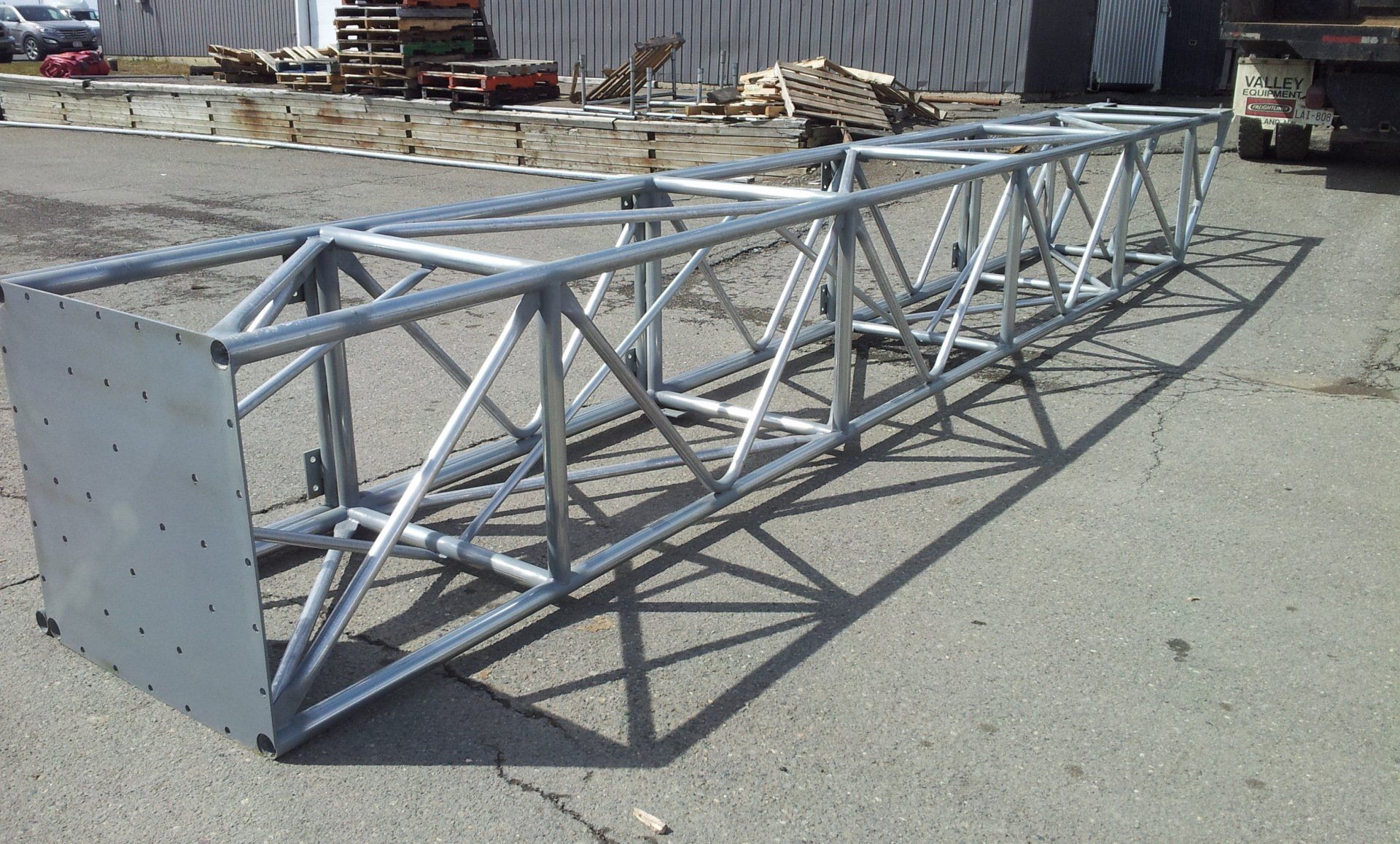 A large metal structure is sitting on the side of the road