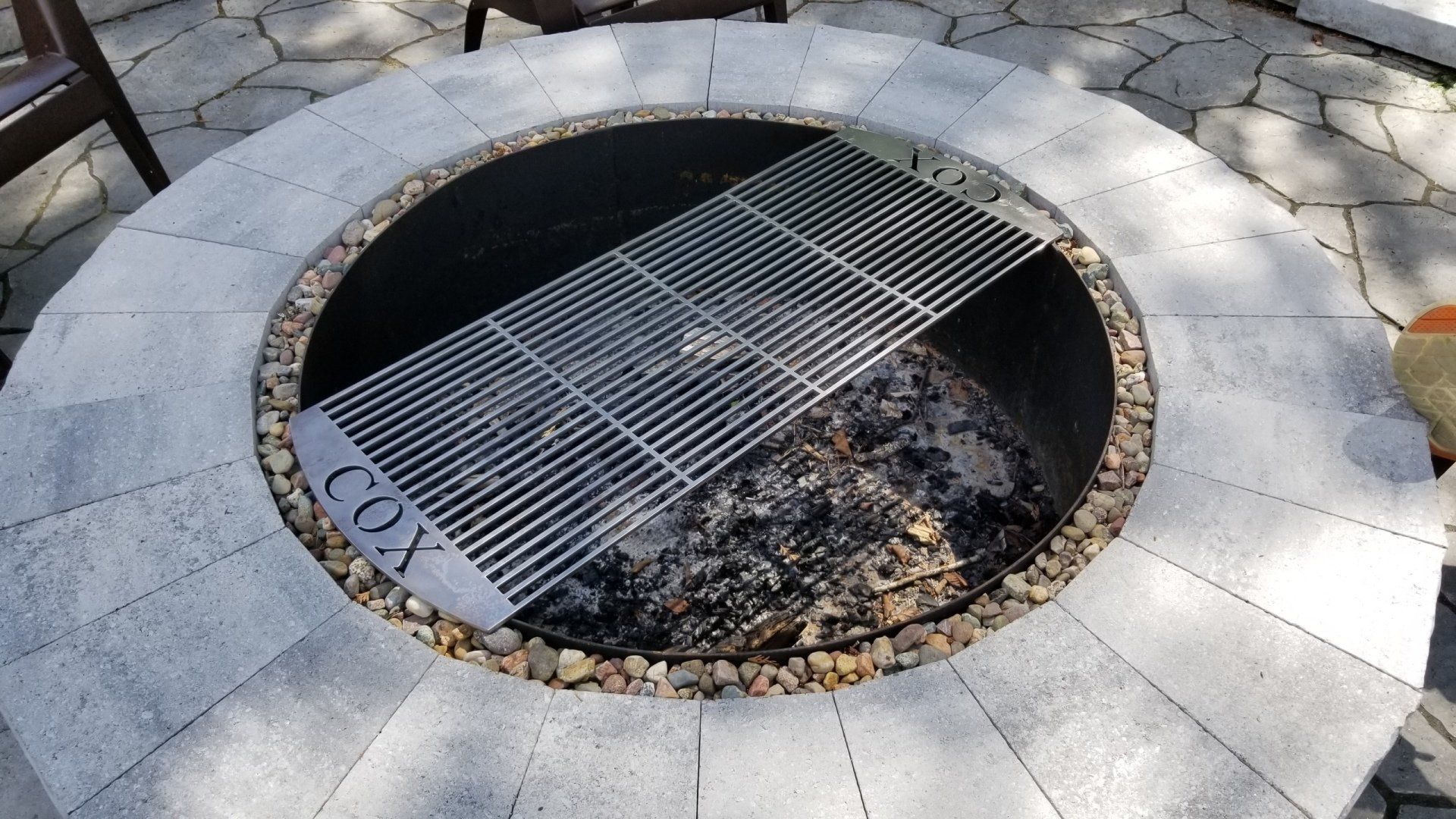 A fire pit with the word cox written on it
