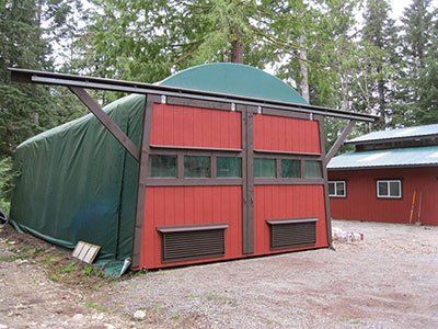 A red building with a green tarp on top of it