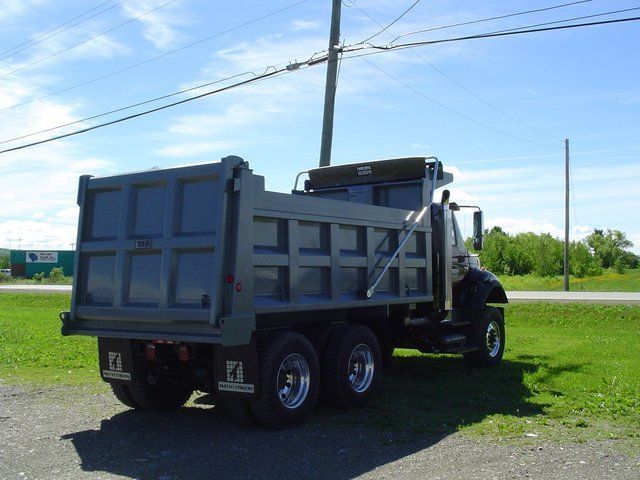 A dump truck is parked on the side of the road