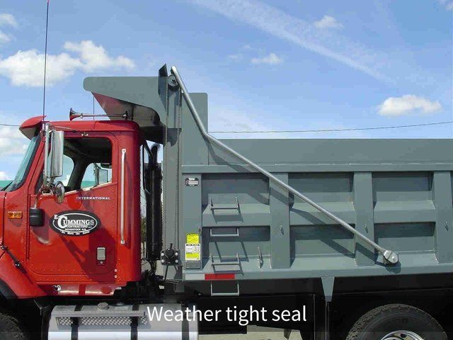 A dump truck has a weather tight seal on the side