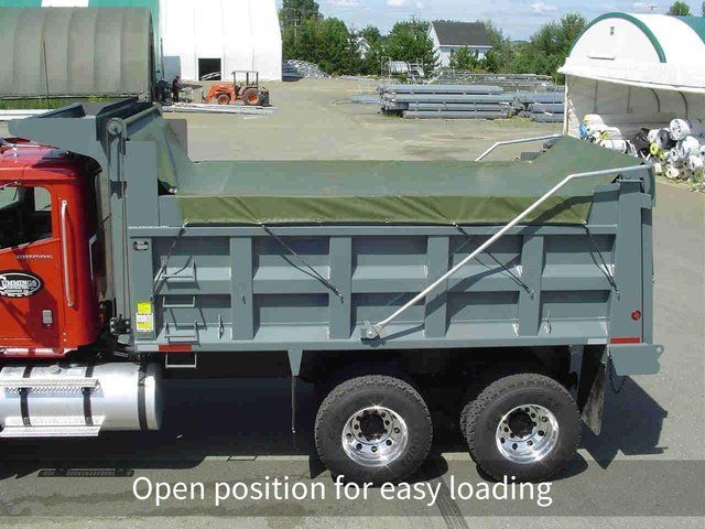 A dump truck is parked in an open position for easy loading