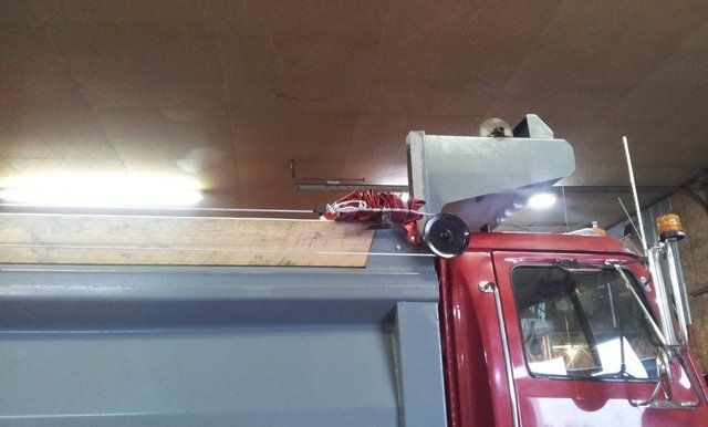 A red dump truck with a speaker on top of it