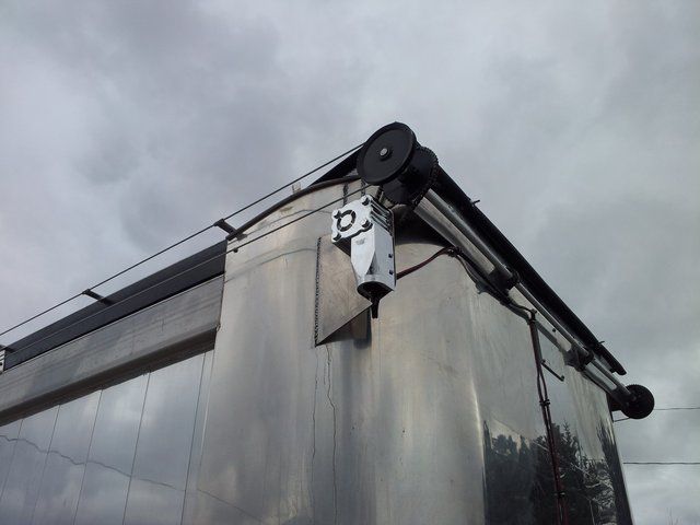 A camera on the side of a building with the letter d on it