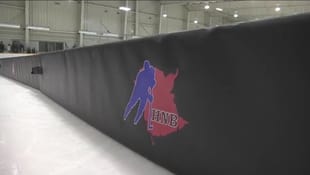 A black wall with a red , blue and white logo on it.