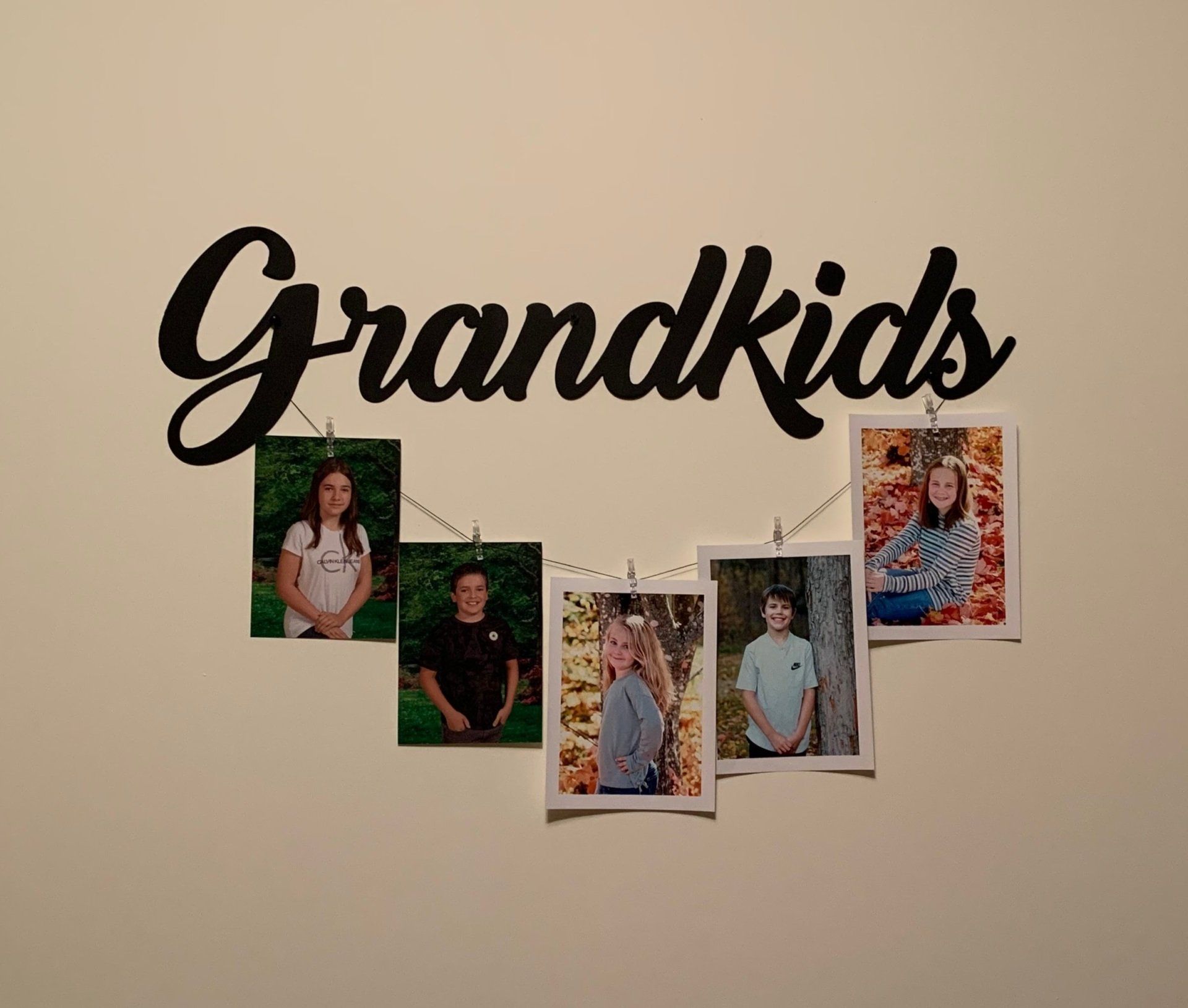 A sign that says grandkids is hanging on a wall