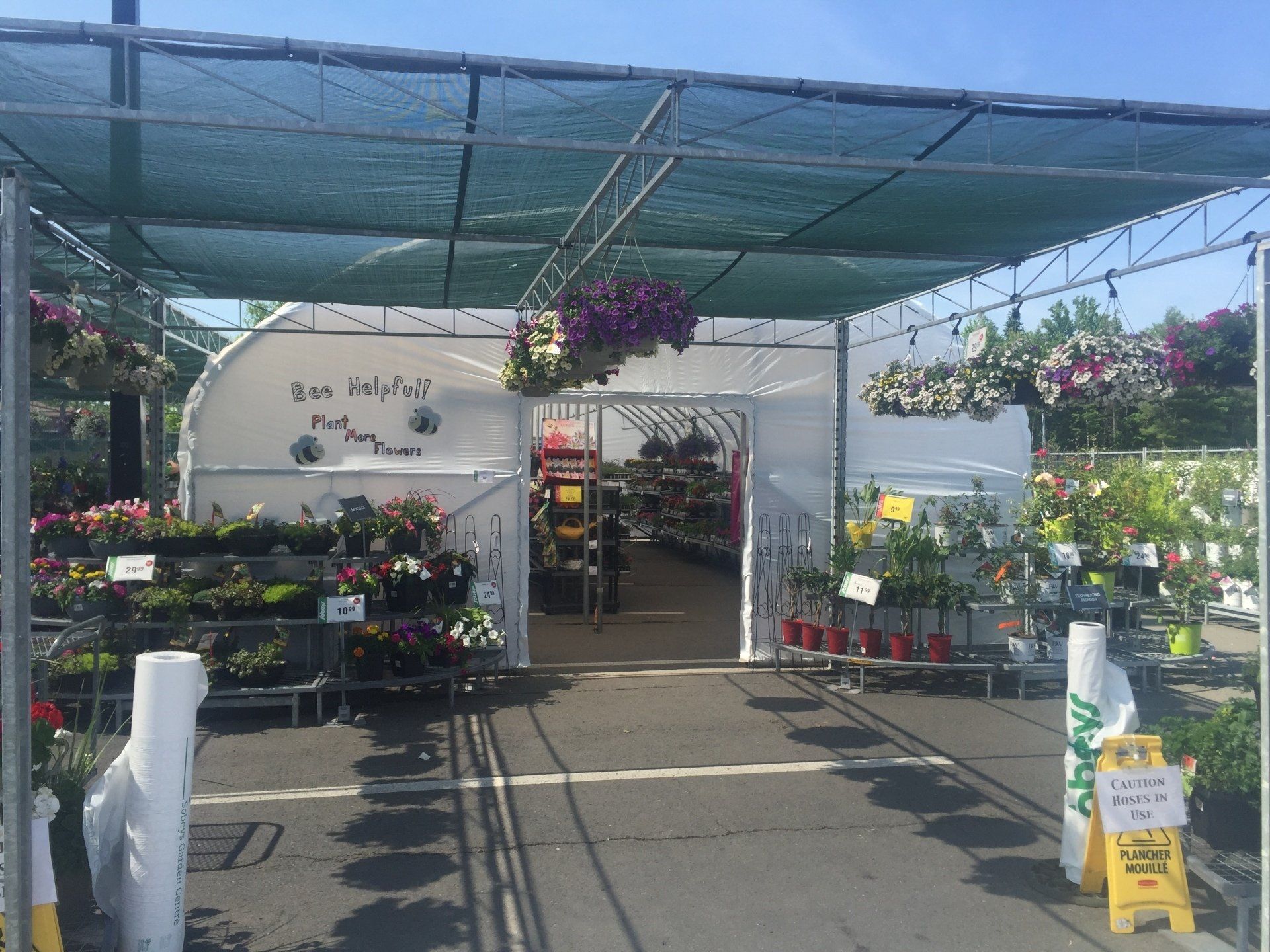 A garden center with a sign that says wet floor