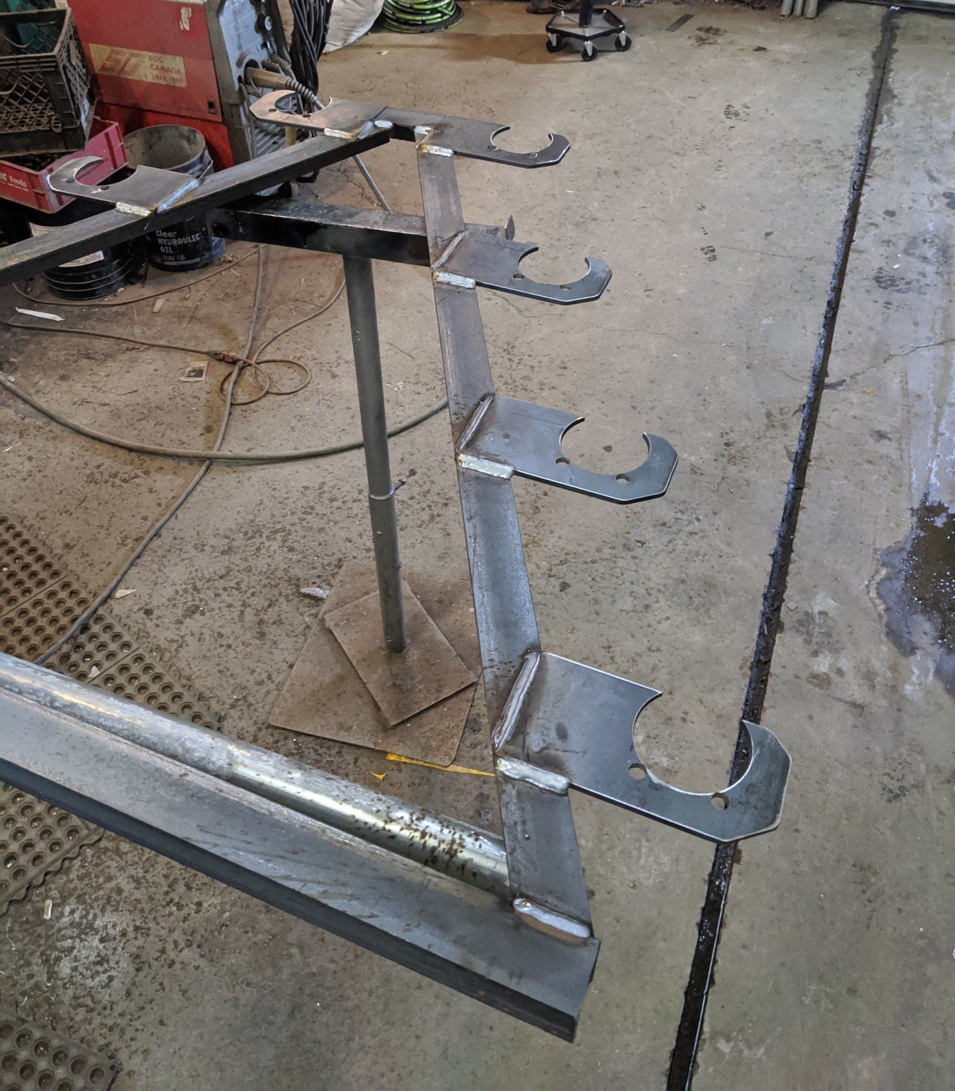 A metal staircase is being built in a garage.