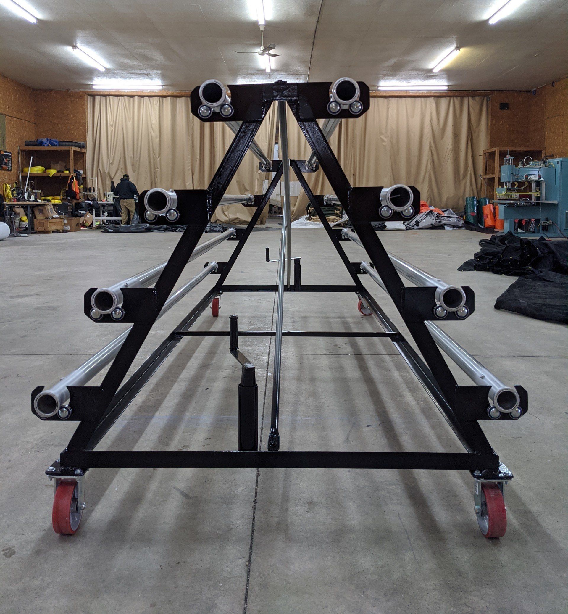 A large metal structure with wheels in a room