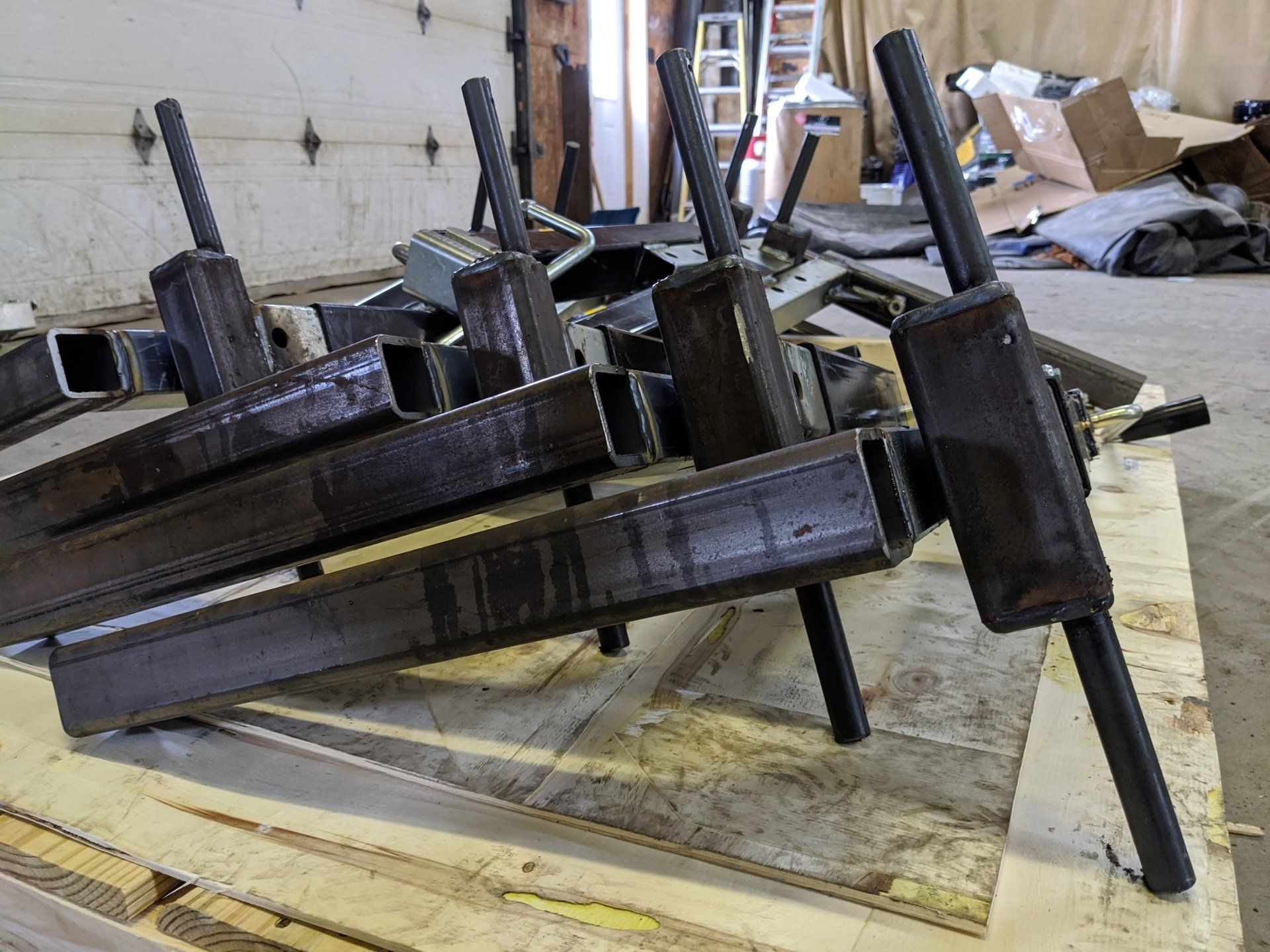 A bunch of metal pieces are stacked on top of each other on a wooden table.