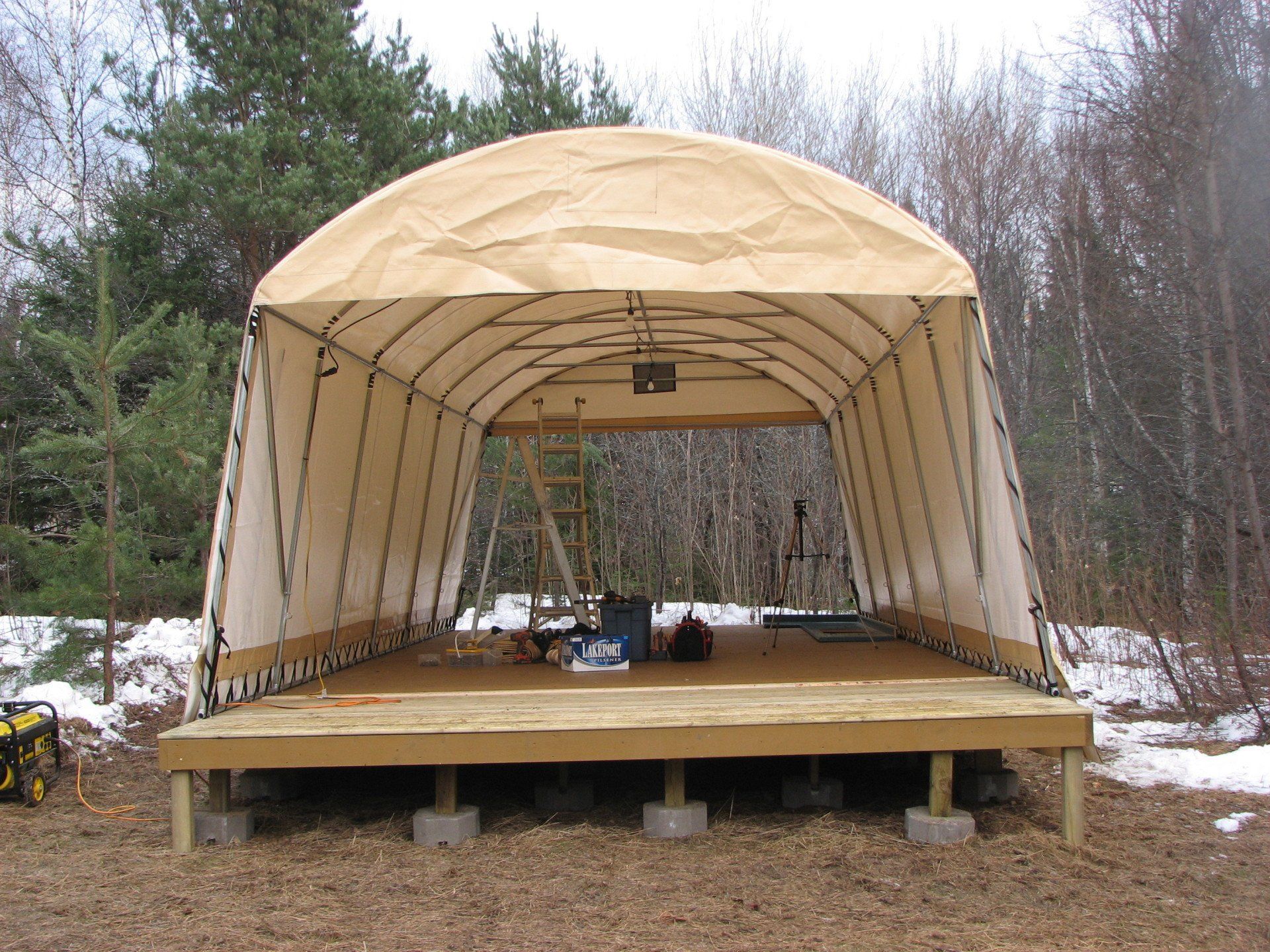 A large tent with a wooden deck underneath it