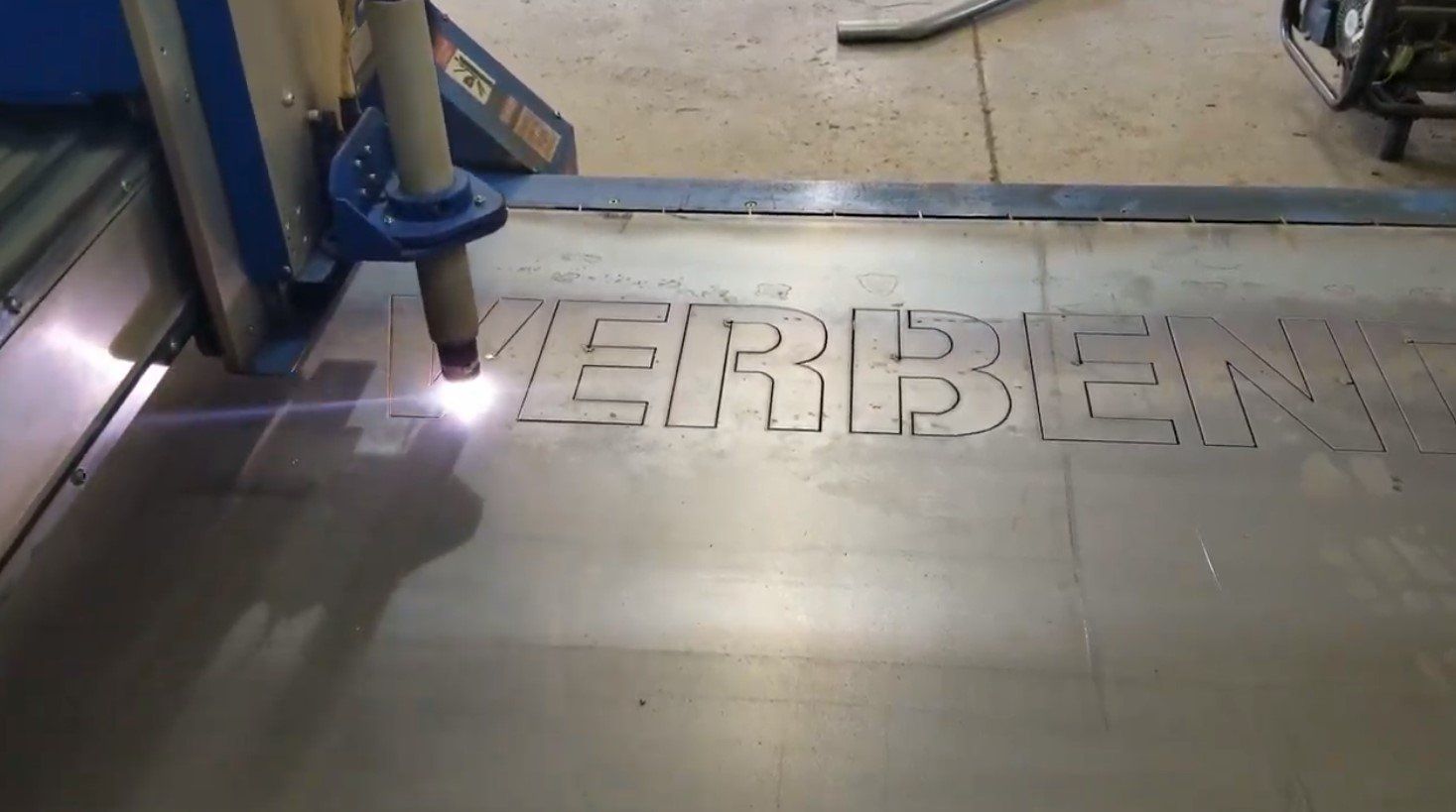 A machine is cutting a piece of metal with a laser.