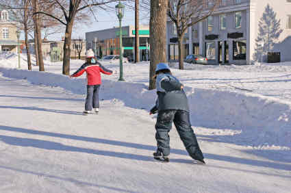 A couple of people are ice skating on a rink.