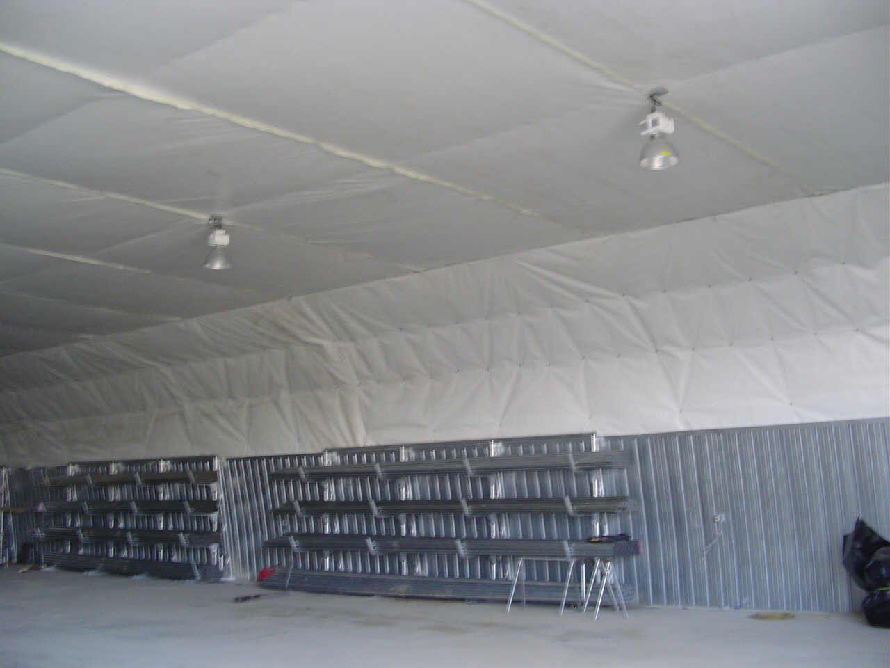 A large room with a lot of shelves and lights on the ceiling