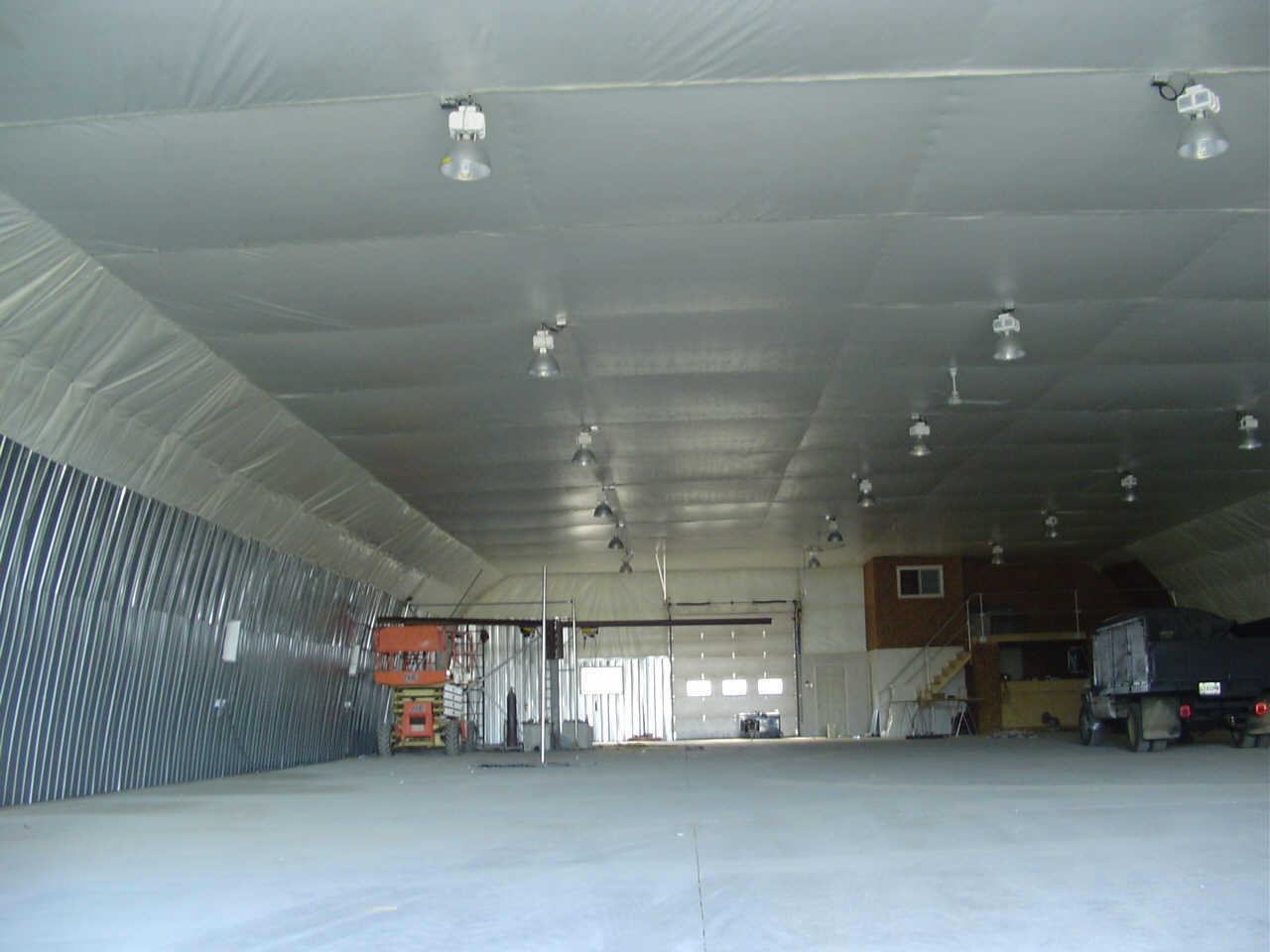 A large empty building with a lot of lights on the ceiling