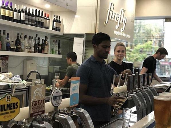 Bar staff pouring drinks