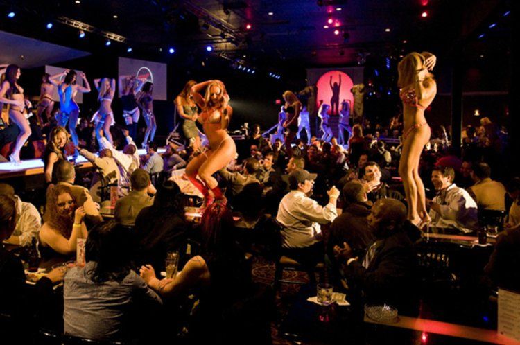 A crowd of people are watching a show in a club