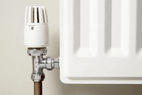  A radiator pipe and the bottom corner of a radiator